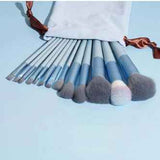 Petra store 13-Piece Makeup Brush Set with soft bristles and blue handles in a white drawstring pouch