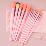 Petra store 13-Piece Makeup Brush Set with pink handles and soft bristles on a pink towel