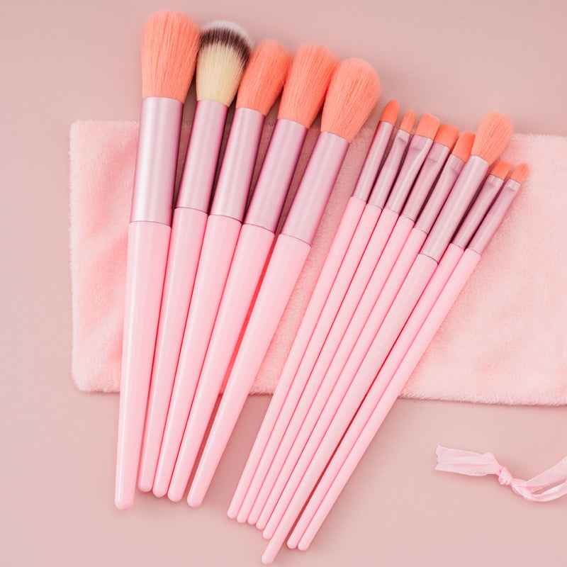 Petra store 13-Piece Makeup Brush Set with pink handles and soft bristles on a pink towel