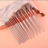 Petra store 13-Piece Makeup Brush Set with white handles and rose gold ferrules on peach background