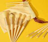 Petra store 13-Piece Makeup Brush Set with soft bristles and beige handles on yellow background