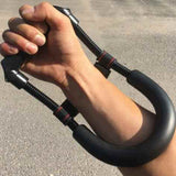 Person using a black Adjustable Arm Trainer with spring resistance for arm and forearm strengthening
