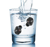 Black Bluetooth earbuds with charging case submerged in water showing waterproof feature