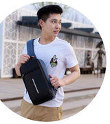 Man wearing black chest bag from Petra store with adjustable strap outdoors in casual outfit