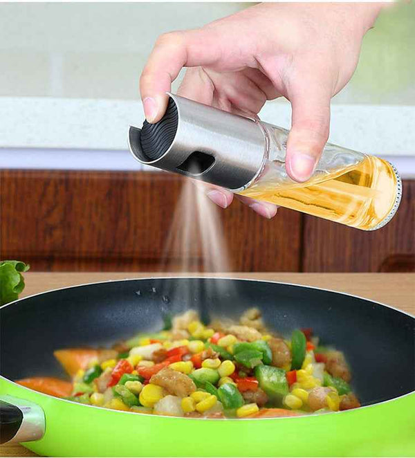 Petra store Cooking Oil Spray Bottle spraying oil over colorful vegetable stir fry in green pan