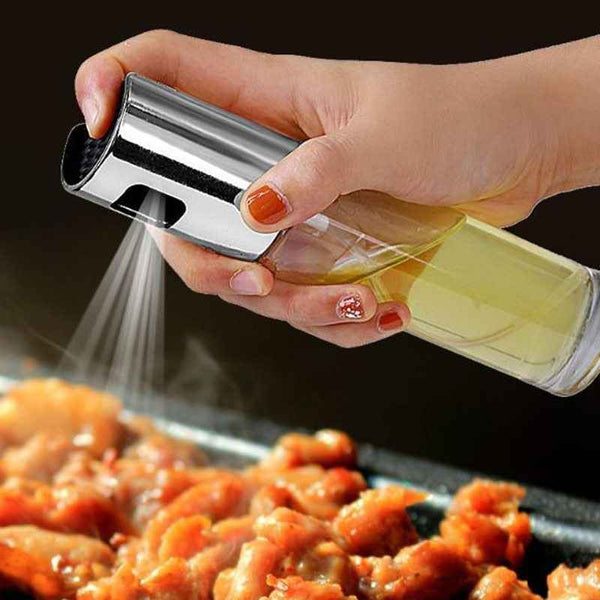Petra store Cooking Oil Spray Bottle spraying oil over sizzling cooked meat in a kitchen