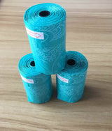 Rolls of blue pet waste bags for Cat Litter Shovel Set by Petra store on wooden surface