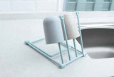 Petra store foldable dishcloth shelf drying rack with two upside-down cups on kitchen counter