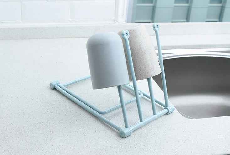 Petra store foldable dishcloth shelf drying rack with two upside-down cups on kitchen counter