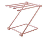 Petra store foldable dishcloth shelf in pink metal with multiple rods for drying and organizing cloths