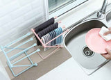 Petra store foldable dishcloth shelf in pink and blue holding drying towels beside kitchen sink