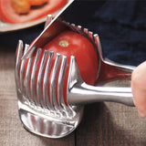 Stainless steel lemon slicer cutting a tomato with evenly spaced blades for uniform slices