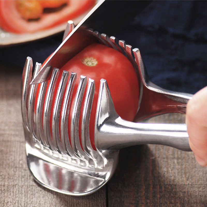 Stainless steel lemon slicer cutting a tomato with evenly spaced blades for uniform slices