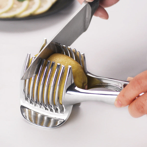Petra store stainless steel lemon slicer held in hand slicing a lemon with a knife
