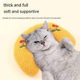 Gray cat resting on a thick and full Little Pillow For Pets with yellow fabric and red flower designs