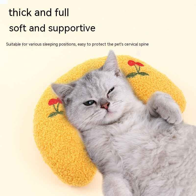 Gray cat resting on a thick and full Little Pillow For Pets with yellow fabric and red flower designs