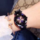 Petra store Rose Gold Watch styled on wrist with black faceted dial crystal hour markers and cuff bracelet