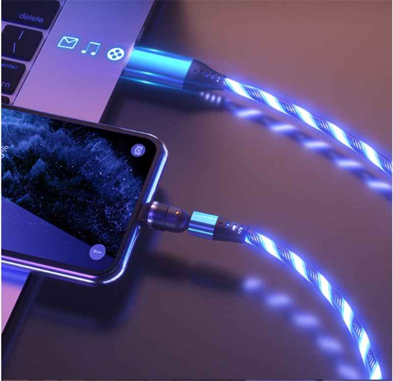 Luminous Magnetic Cable glowing blue while charging a smartphone and laptop on a dark surface