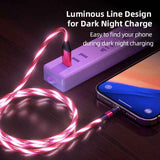 Luminous Magnetic Cable glowing pink while charging a smartphone from a power strip at night