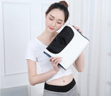 Petra store massage pillow in white and black held by woman in white crop top and gray pants