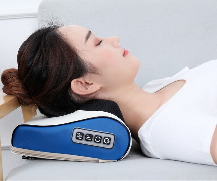 Petra store blue and white massage pillow with control buttons used by woman lying on couch