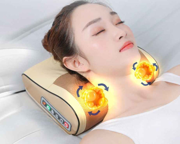 Woman relaxing with Petra store massage pillow providing neck and shoulder shiatsu massage