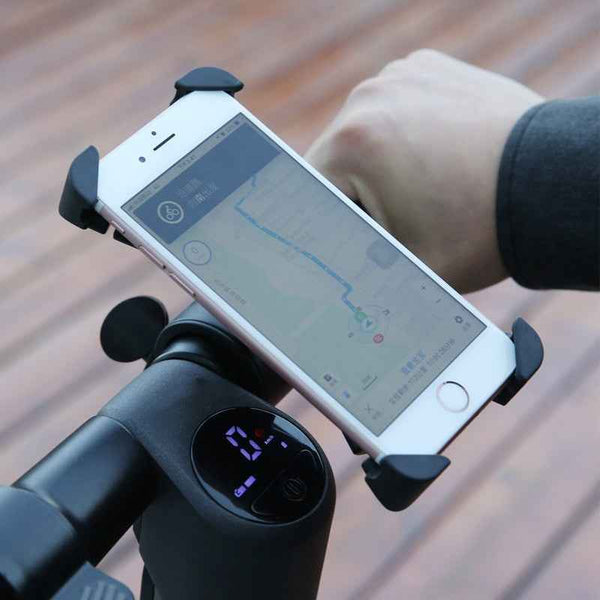 Mountain Bike Smartphone Holder by Petra store securing a phone displaying a navigation map on an electric scooter handlebar