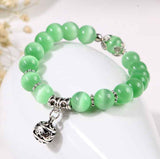 Natural opal beads bracelet with green rounded stones and silver charm from Petra store