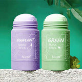 Petra store Cleansing Green Tea Mask stick in green packaging next to purple eggplant mask stick on textured surface