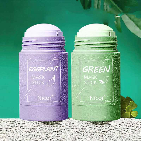 Petra store Cleansing Green Tea Mask stick in green packaging next to purple eggplant mask stick on textured surface