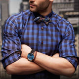 Petra store Leather Sports Watch with blue dial and brown leather strap on man in plaid shirt
