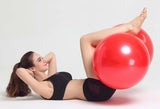 Woman lying on floor exercising with red Peanut Massage Ball between her legs from Petra store