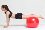 Woman exercising with a red Peanut Massage Ball for muscle relief and skincare wellness
