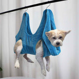 Pet Grooming Hammock in blue holding small dog securely for easy grooming and care