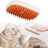 Pets Steam Brush from Petra store with orange bristles grooming a gray tabby cat