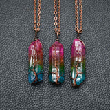 Colorful crystal Pillar Tree Of Life Pendant necklaces with copper wire wrapping on black textured background