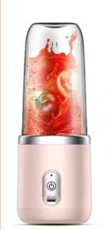 Petra store Portable Blender And Mini Juicer with a pink base blending fresh red fruits and vegetables