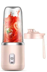Petra store Portable Blender And Mini Juicer in pink with fresh fruit inside and detachable lid