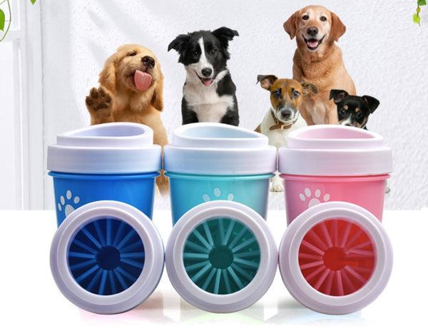 Petra store portable pet paw cleaning tool in blue teal and pink with dogs in background