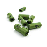 Green pet waste bags with paw prints on white background from Petra store pet accessories