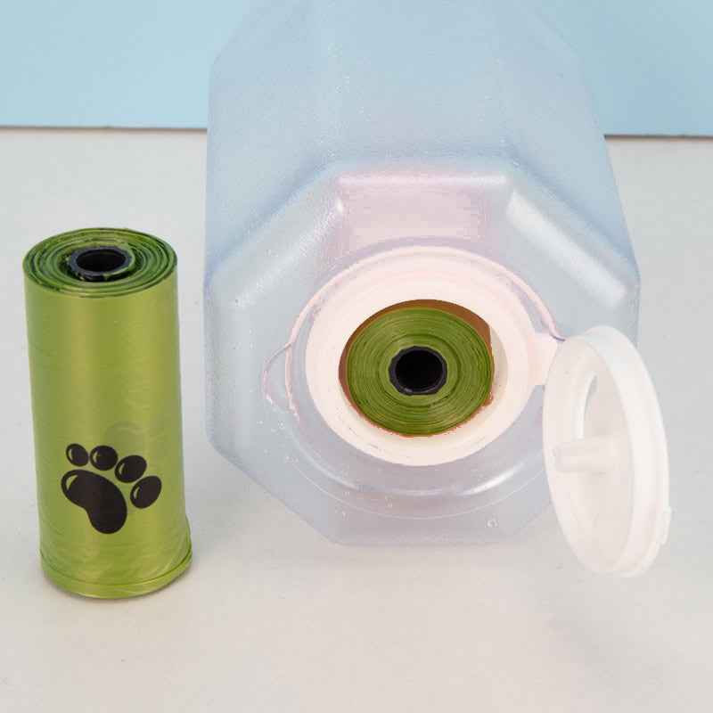 Green pet waste bag roll next to the opening of a portable pet water bottle from Petra store