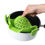 Green Pot Side Drain Stopper attached to white pot with black interior for easy draining