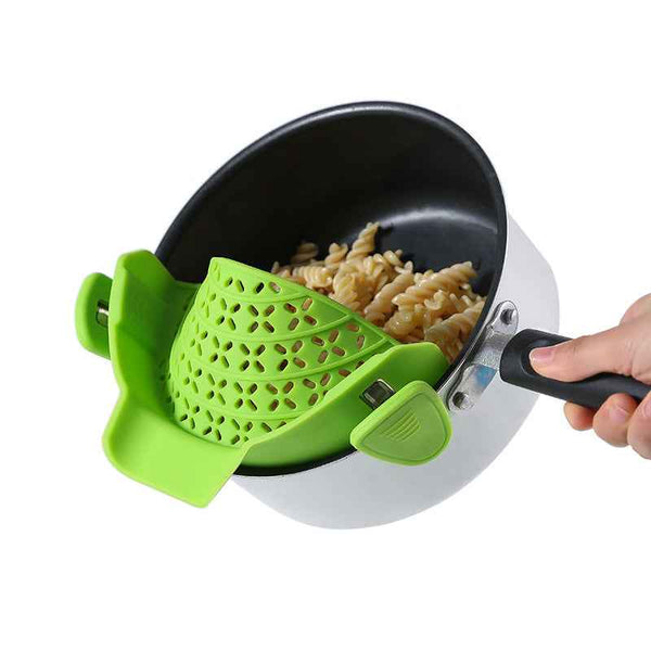 Green Pot Side Drain Stopper attached to pot straining cooked pasta for easy draining
