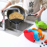 Pot Side Drain Stopper in use draining pasta over kitchen sink with colorful silicone kitchen tools