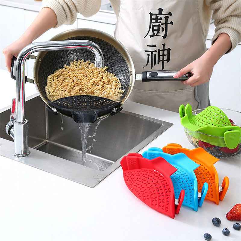 Pot Side Drain Stopper in use draining pasta over kitchen sink with colorful silicone kitchen tools