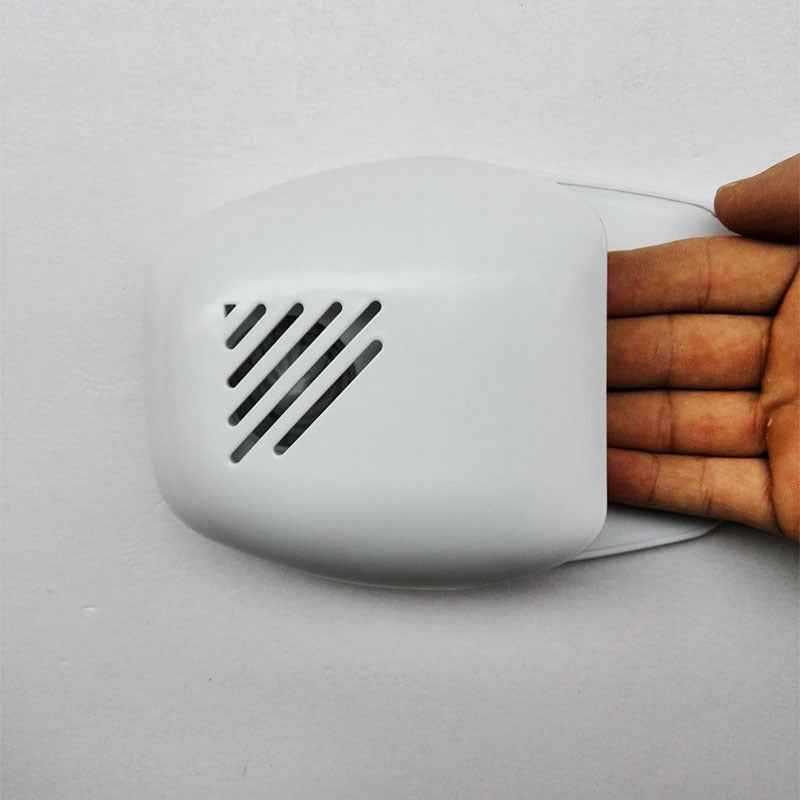 White Mini Nail polish Dryer from Petra store with hand placed underneath for drying nails