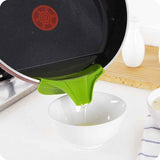 Green Silicone Soup Funnel attached to pan pouring liquid into white bowl in kitchen