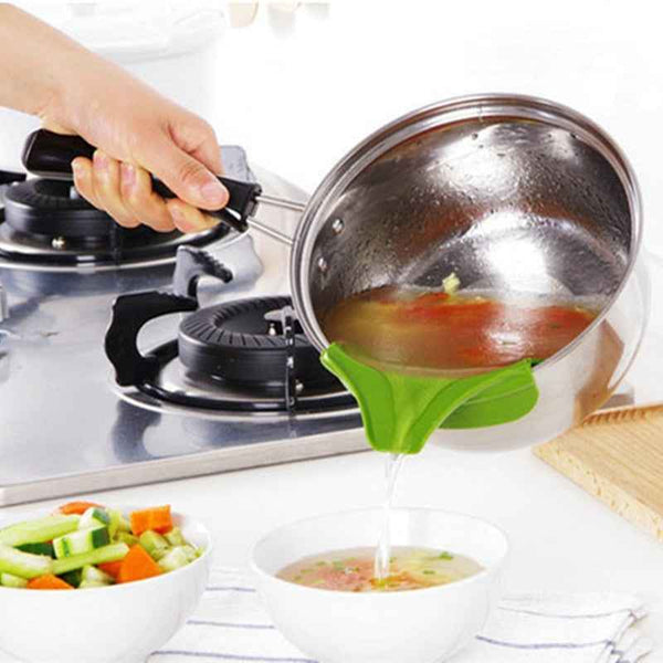 Pouring soup with a green Silicone Soup Funnel from a pot into a white bowl in a modern kitchen