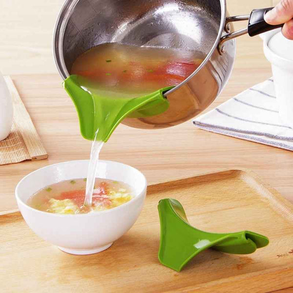 Green Silicone Soup Funnel from Petra store pouring soup from pot into white bowl on wooden tray