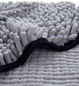 Close-up of Petra store Super Absorbent Pets Bathrobe fabric showing gray soft textured microfiber material with black trim